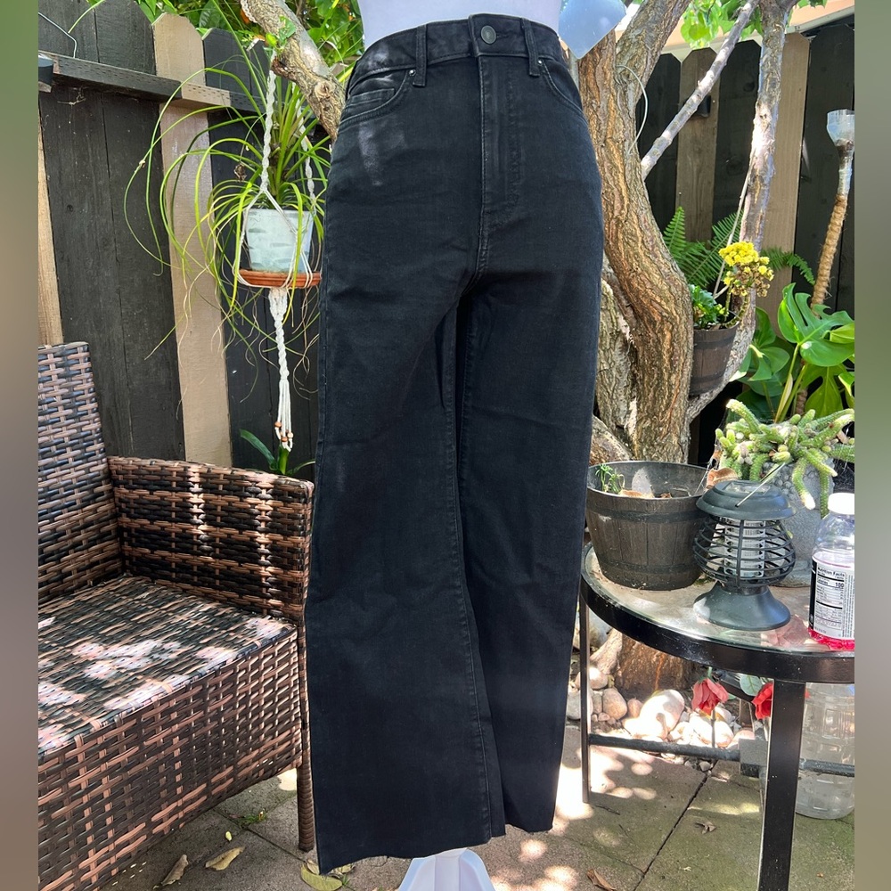 High-waisted black wide-leg jeans with frayed hem
